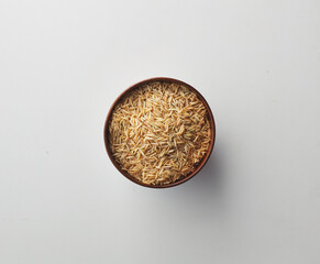 Top view shot of brown rice on white background.