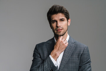 Photo of respectable confident businessman posing and looking at camera