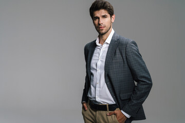 Photo of respectable confident businessman posing and looking at camera