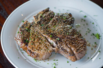Steak. Grass-fed skirt steak, grilled to a medium rare and served with a garlic herb butter sauce and paired with roasted potatoes and Brussels sprouts. Classic American steakhouse favorite.