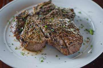 Steak. Grass-fed skirt steak, grilled to a medium rare and served with a garlic herb butter sauce and paired with roasted potatoes and Brussels sprouts. Classic American steakhouse favorite.