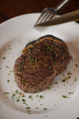 Steak. Grass-fed skirt steak, grilled to a medium rare and served with a garlic herb butter sauce and paired with roasted potatoes and Brussels sprouts. Classic American steakhouse favorite.