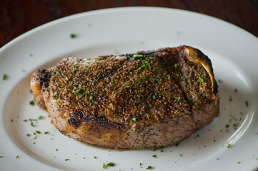 Steak. Grass-fed skirt steak, grilled to a medium rare and served with a garlic herb butter sauce and paired with roasted potatoes and Brussels sprouts. Classic American steakhouse favorite.