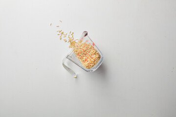 Top view shot of brown rice on white background.