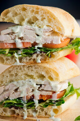 Chicken sandwiches served on toasted whole grain bread with melted Swiss cheese, mayonnaise and seasoned salt and pepper.  Classic American restaurant or diner lunch or brunch sandwich favorite.
