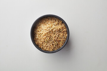 Top view shot of brown rice on white background.