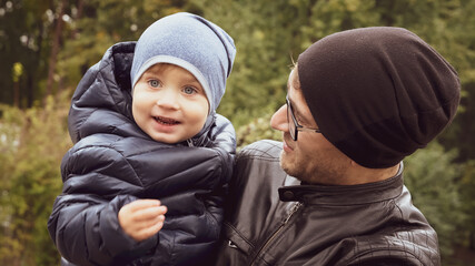 Fototapeta premium father carries son on his shoulder