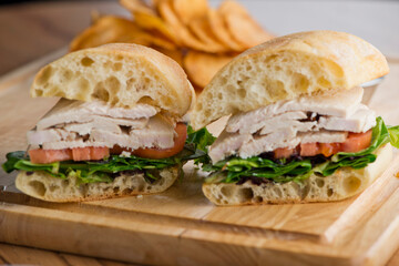 Chicken sandwiches served on toasted whole grain bread with melted Swiss cheese, mayonnaise and seasoned salt and pepper.  Classic American restaurant or diner lunch or brunch sandwich favorite.