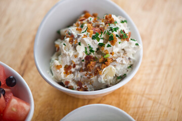 Steakhouse side dishes. Asparagus, salad, tomatoes, mashed potatoes, red onions, cream cauliflower, pickled peppers, seasoned meats served in cast iron skillet. Traditional appetizer items.