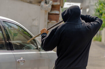 Burglar trying to break into a car with a crowbar