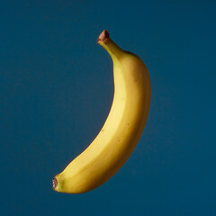 Fruit pop art yellow banana blue color background art side lighting 