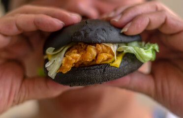 Soft focus close up of man eat burger