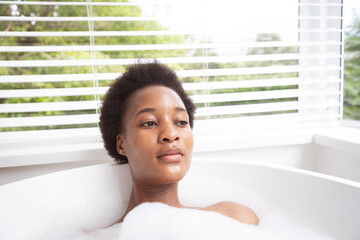 Woman relaxing in a bathtub