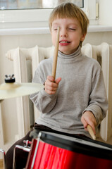 Little boy performing a drum concert early in the morning. Playing like a real Rock Star.