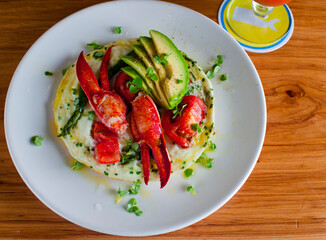 Frittata or omelette lobster avocado. Egg-based Italian dish w/ scrambled eggs, enriched with additional ingredients. classic seafood restaurant brunch/breakfast menu item. Maine lobster frittata. 