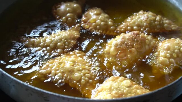 Deep fried Malaysia traditional chicken curry puff in the hot boiling oil.