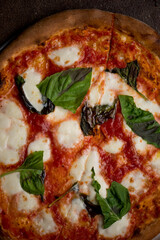 Pizza. Traditional New York City style margarita pizza pie with a thin homemade crispy crust, fresh tomato garlic marinara sauce topped with buffalo mozzarella cheese and fresh basil leaves.