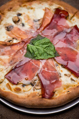 Pizza. Traditional New York City style margarita pizza pie with a thin homemade crispy crust, fresh tomato garlic marinara sauce topped with buffalo mozzarella cheese and fresh basil leaves.