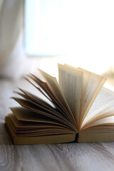 Open book on a table. Selective focus.