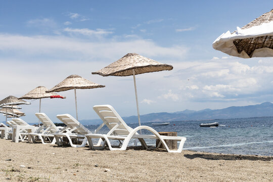 Sun beds and umbrellas by the sea.