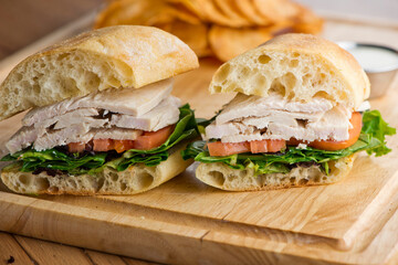 Chicken sandwiches served on toasted whole grain bread with melted Swiss cheese, mayonnaise and seasoned salt and pepper.  Classic American restaurant or diner lunch or brunch sandwich favorite.