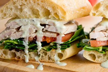 Chicken sandwiches served on toasted whole grain bread with melted Swiss cheese, mayonnaise and seasoned salt and pepper.  Classic American restaurant or diner lunch or brunch sandwich favorite.