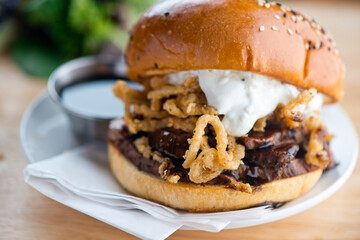 Roast Beef Sandwich. Classic Traditional american Diner sandwich. Thinly sliced roast beef topped with melted swiss cheese on top of a toasted hero roll with lettuce tomato and onion. 