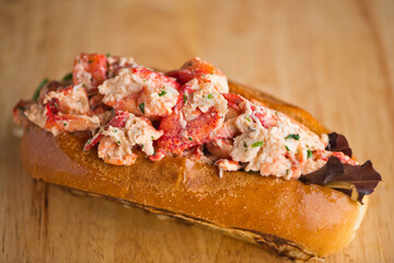 Maine Lobster Roll, traditional classic American Sandwich. New England classic, fresh Maine Lobster in homemade mayo with chives served in soft hero roll with crisp lettuce.