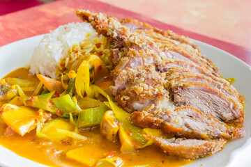 Thai dish with roasted duck, rice and vegetables in curry sauce