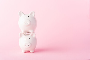 International Friendship Day, Front stack two small white fat piggy bank, studio shot isolated on pink background and copy space for use, Finance, deposit saving money concept