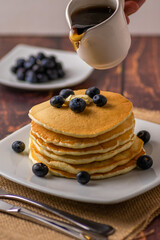 Verical image of pancakes about to be poured
