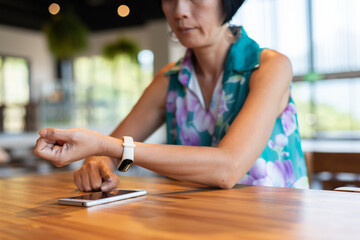woman using smartphone with smart watch