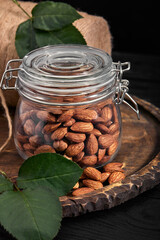 glass jar with almond on wooden board Vitamin food