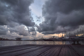 Fototapeta na wymiar Valencia Harbour with moody sky during sunset