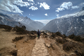 Fototapeta na wymiar Female hiker with Himalayan mountains as background