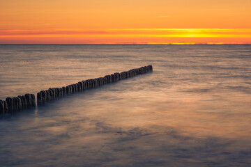 Naklejka premium Sunset on the Baltic Sea in Miedzyzdroje, Zachodniopomorskie, Poland