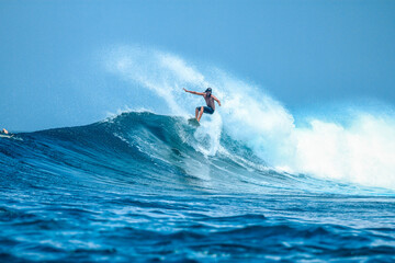 Surfer on perfect blue aquamarine wave, empty line up, perfect for surfing, clean water, Indian...