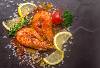 Close up  shrimp with seasoning spice and herb on black background.