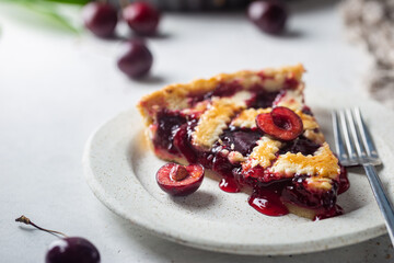 piece of Delicious homemade classic cherry pie with a flaky crust on white background