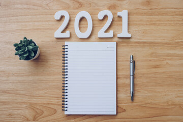 New year 2021 list. Office desk table with notebooks and pancil with pot plant.