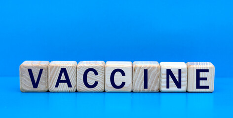 concept word VACCINE on cubes on a blue background