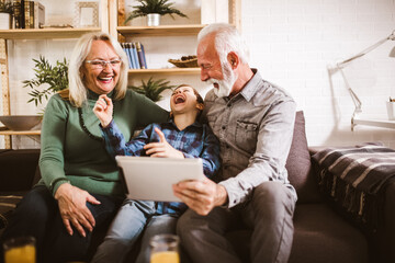 Young boy showing his older grandparents new technology