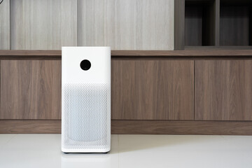 Indoor air purifier with digital monitor screen in living room, show air quality in the room and air pollution levels in the room. with wood laminate wall background