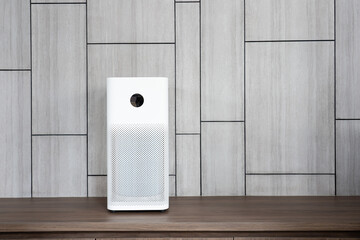 Indoor air purifier with digital monitor screen in living room, show air quality in the room and air pollution levels in the room. with wood laminate wall background