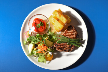 Steak with chips salad and asparagus 