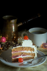 Portion of vanilla and cream cake on ceramic plate