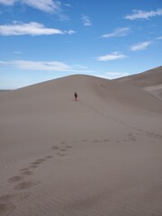 Man on a sand dune from a distance