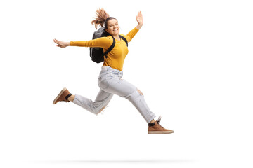 Fototapeta na wymiar Female student with a backpack jumping high