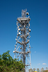 Radio and communications mast on Butser Hill, Petersfield, Hampshire the highest point on the southdowns.  Shown against a deep blue sky.