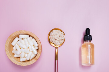 Collagen products serum, powder and pills on pink background